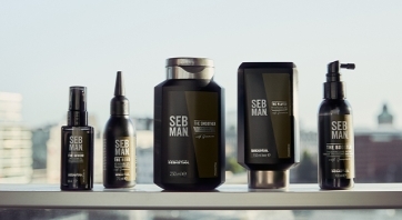 Set of Seb Man products standing on a steel railing, blurred city in the background